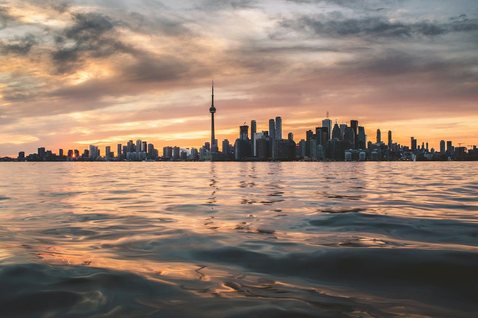 The Toronto skyline with the CN Tower across Lake Ontario at golden hour